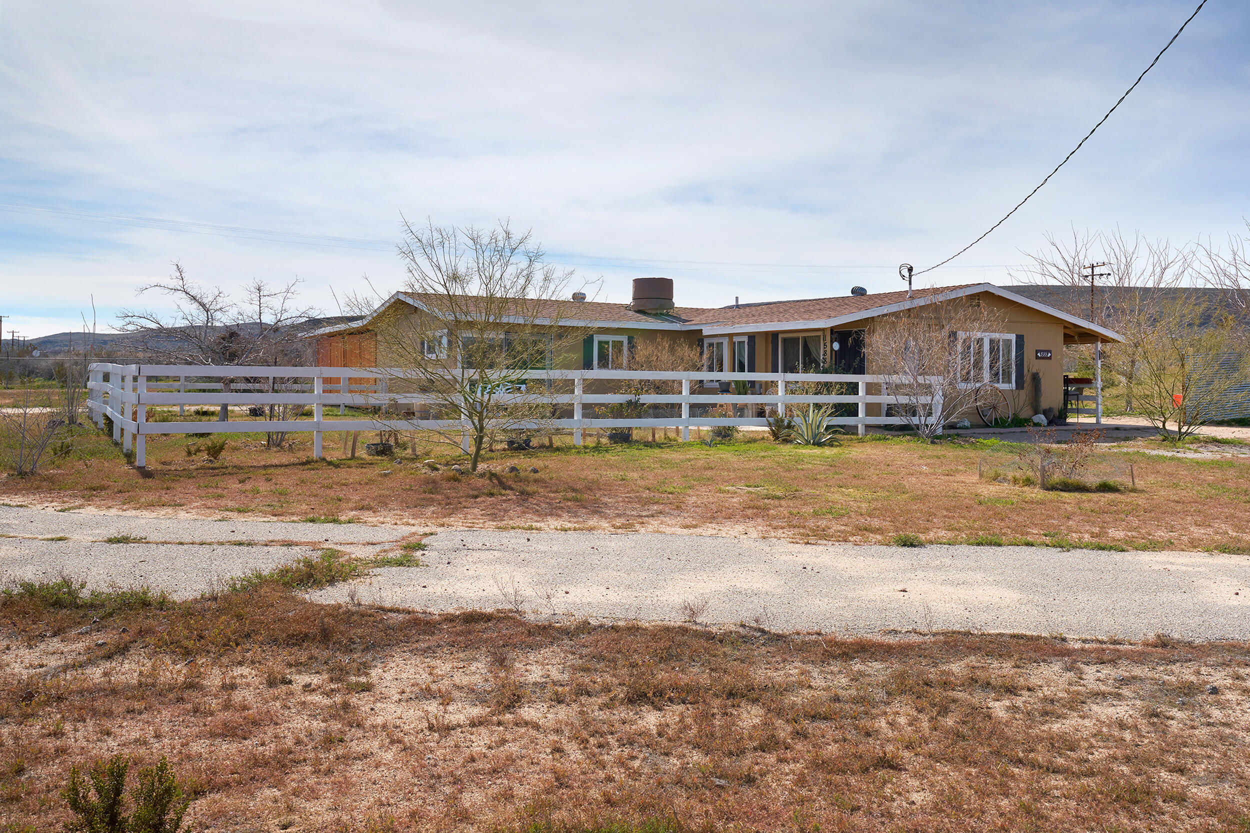 1588 Old Woman Springs Road Yucca Valley, CA 92284 - Photo 32 of 37 a view of a house with a yard and sitting area