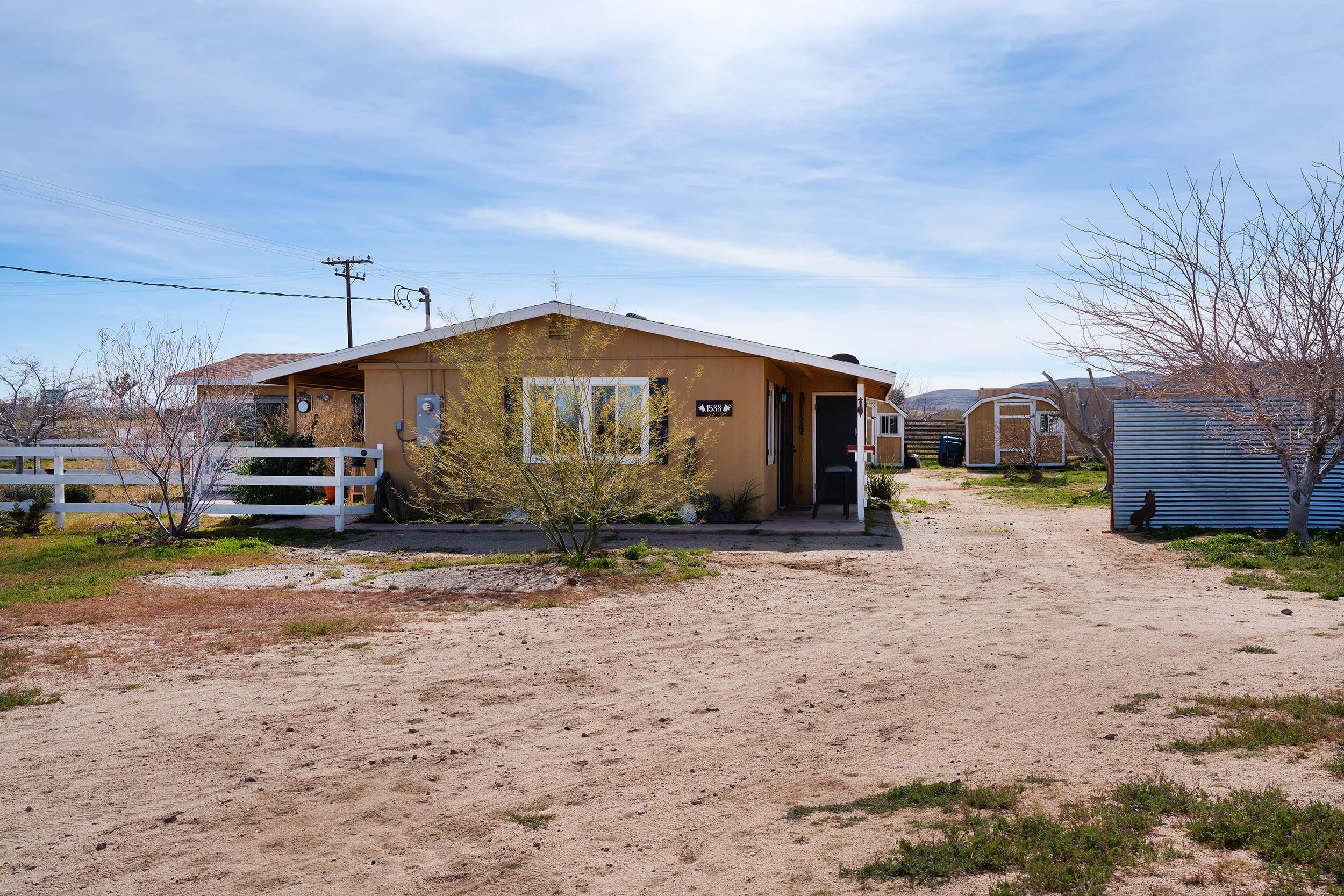 1588 Old Woman Springs Road Yucca Valley, CA 92284 - Photo 4 of 37 a view of a house next to a yard