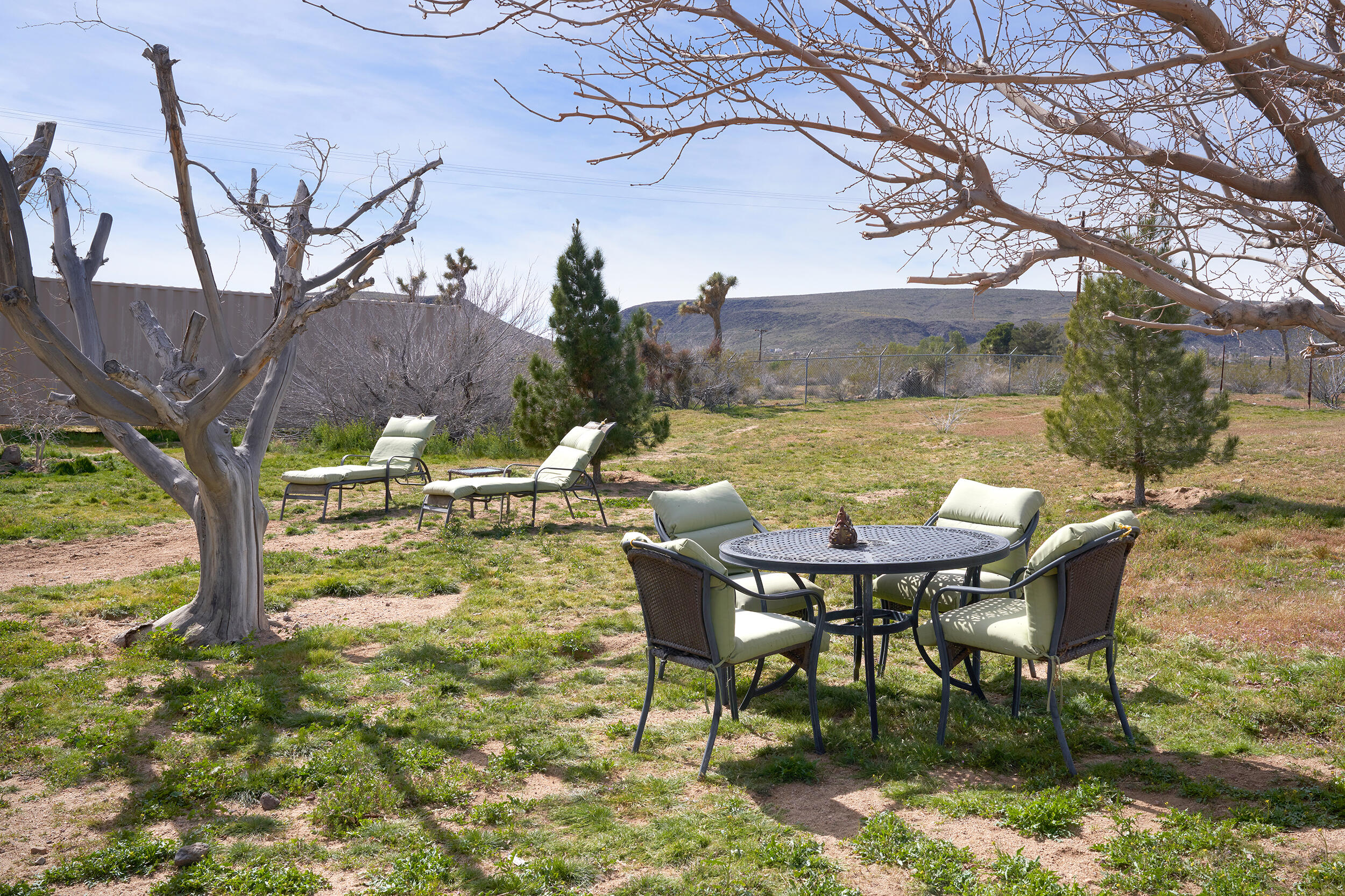 1588 Old Woman Springs Road Yucca Valley, CA 92284 - Photo 7 of 37 a view of a chairs and table in the patio