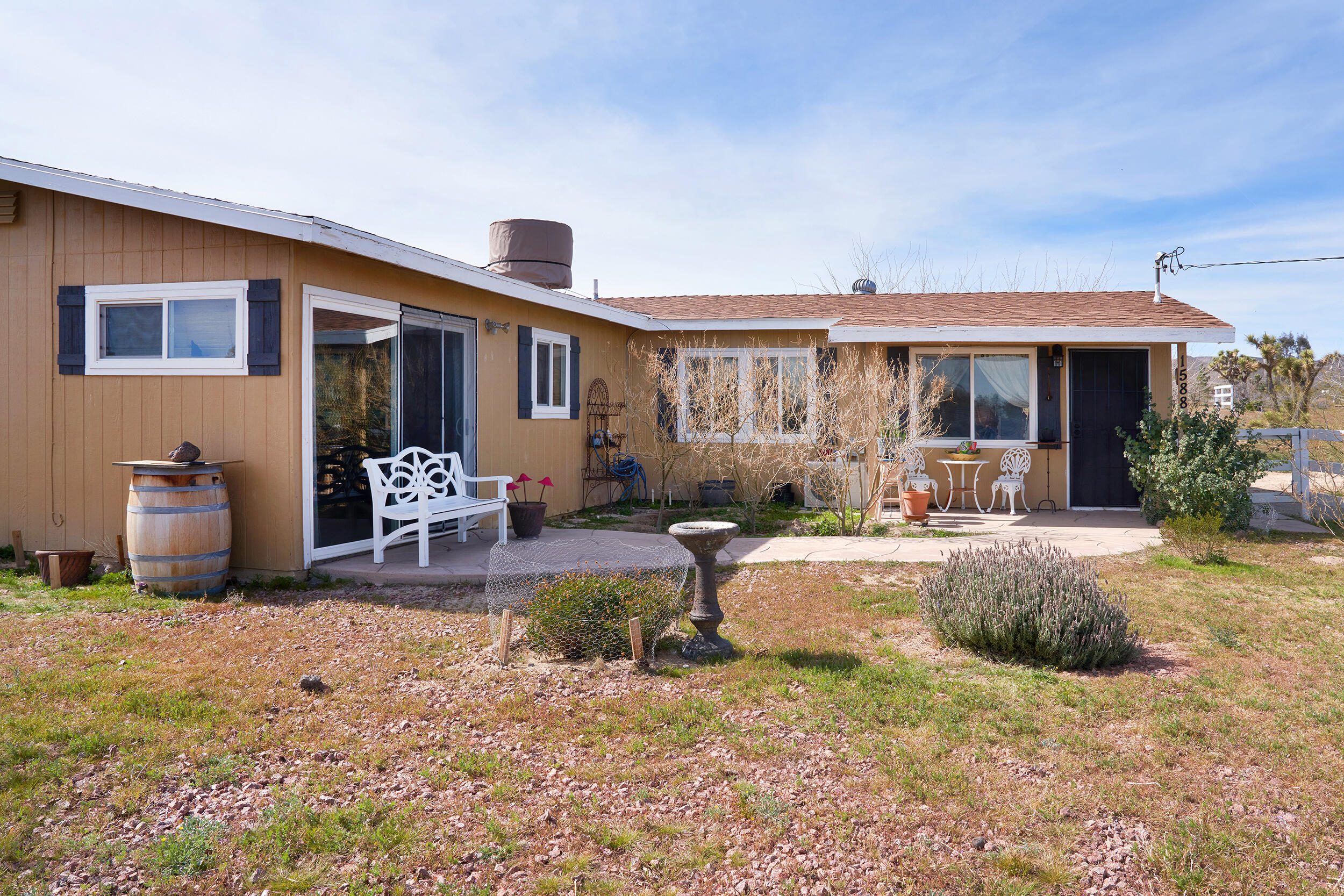1588 Old Woman Springs Road Yucca Valley, CA 92284 - Photo 8 of 37 a view of a house with backyard porch and sitting area