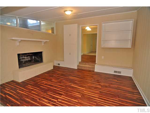 1706 Euclid Road Durham, NC 27713 - Photo 7 of 25 Sitting Area with NEW Laminate Floors, Wood Burning Fireplace and Built-in Cabinets/Shelving.
