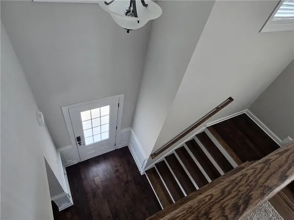 an empty room with a window and ceiling fan
