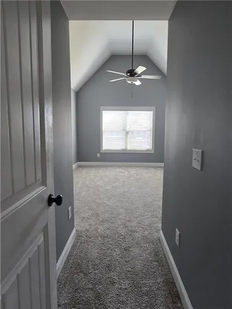 a view of staircase with railing and a window