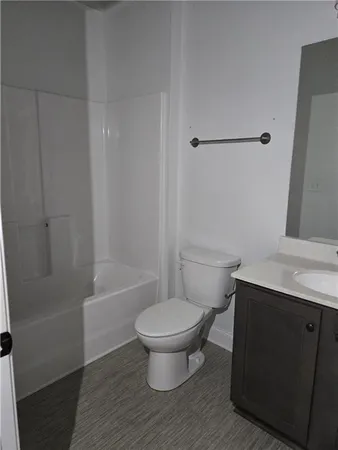 a view of a closet area with wooden floor