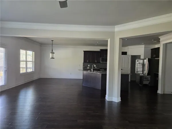 a view of a living room a kitchen and a wooden floor