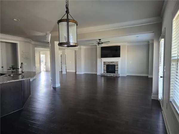 a kitchen with stainless steel appliances granite countertop a refrigerator a stove and a wooden floors