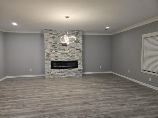 a view of an empty room and wooden floor