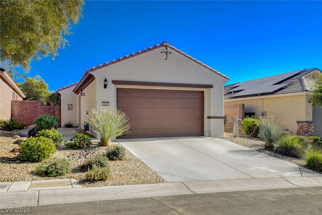 2649 Rue Marquette Avenue Henderson, NV 89044 - Photo 3 of 55 This appealing stucco home features a terracotta-tiled roof and a broad paved driveway.