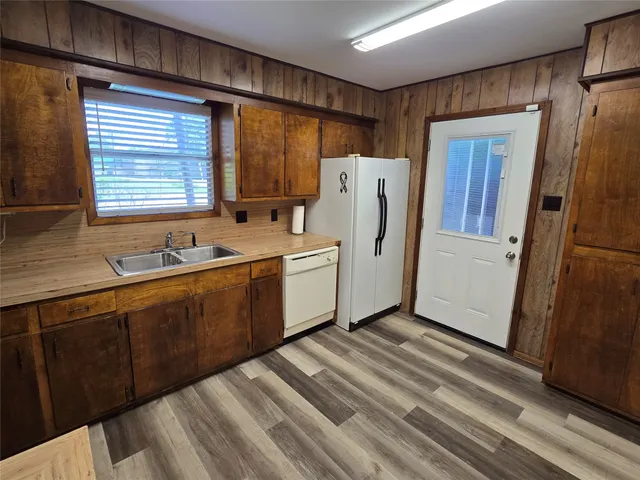 a kitchen with stainless steel appliances granite countertop a refrigerator and a sink
