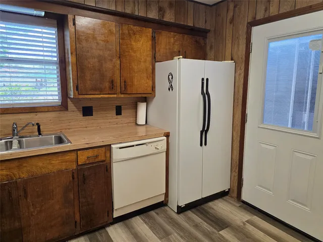 a kitchen with refrigerator and window