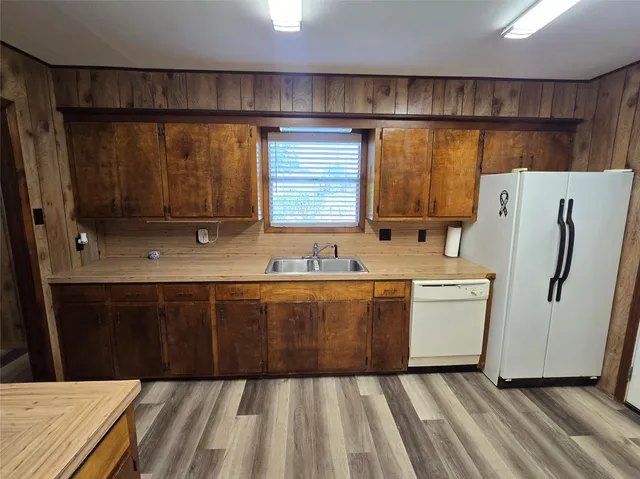 a view of a refrigerator and wooden floor