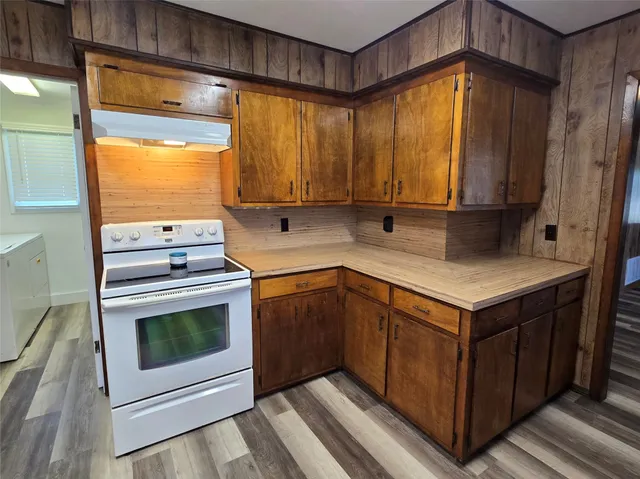 a kitchen with a sink stove and refrigerator