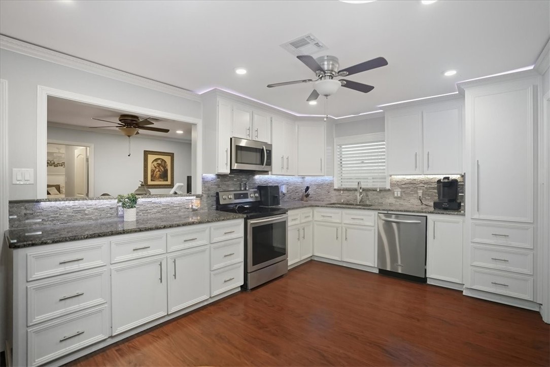 4218 Beard Drive Corpus Christi, TX 78413 - Photo 12 of 31 a kitchen with granite countertop white cabinets and white appliances