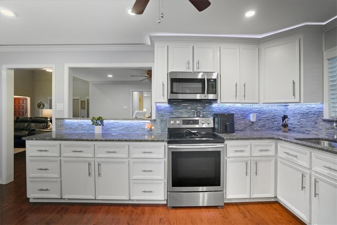 4218 Beard Drive Corpus Christi, TX 78413 - Photo 13 of 31 a kitchen with stainless steel appliances granite countertop a stove a sink and a microwave