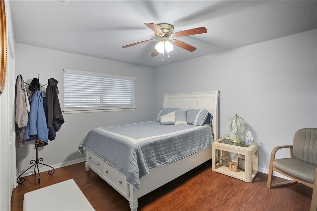 4218 Beard Drive Corpus Christi, TX 78413 - Photo 24 of 31 a bedroom with a bed and a chandelier