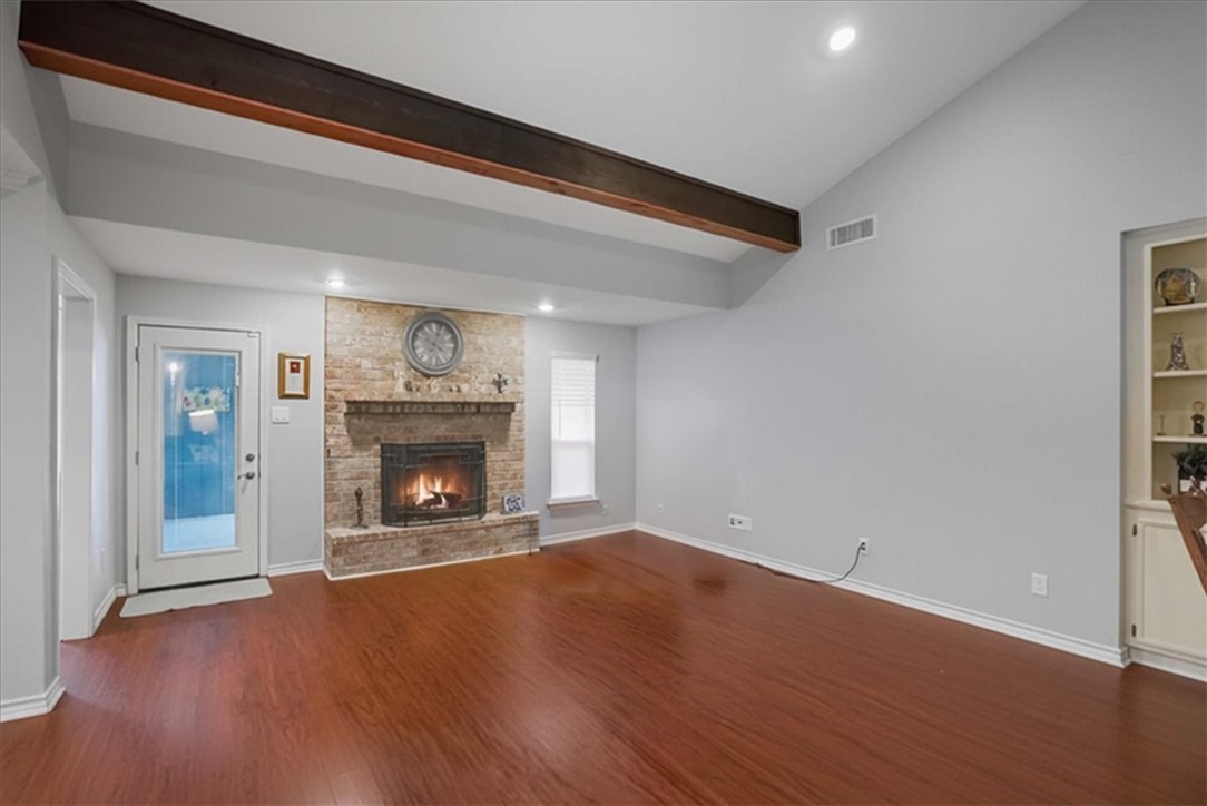 4218 Beard Drive Corpus Christi, TX 78413 - Photo 3 of 31 a view of an empty room with wooden floor fireplace and a window