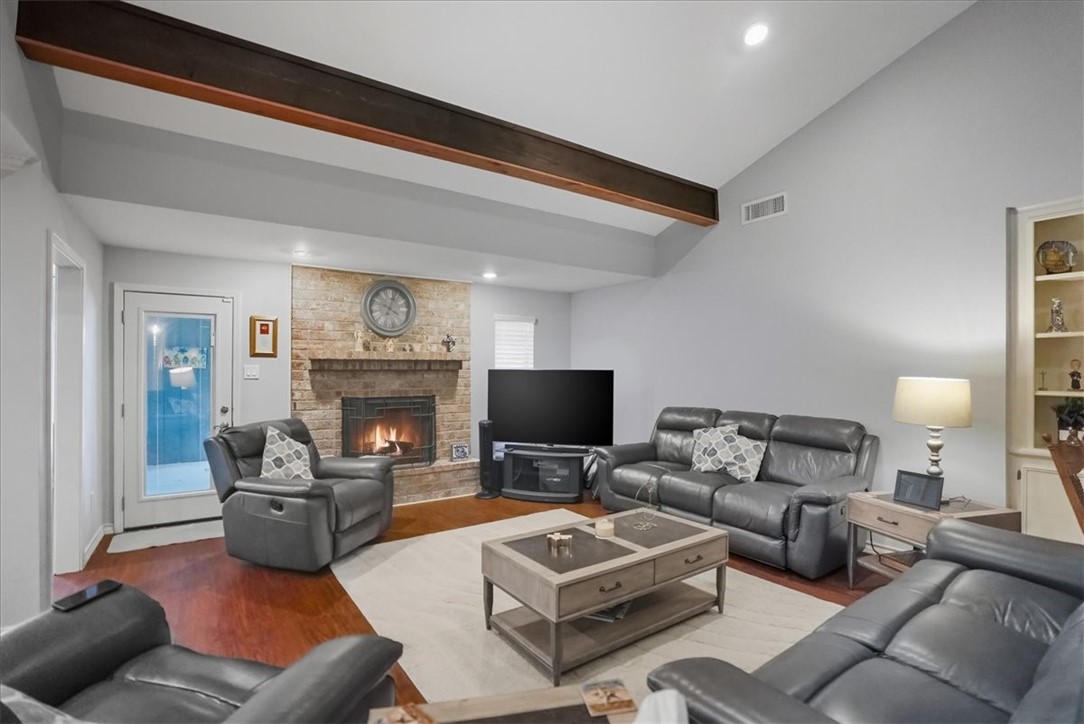 4218 Beard Drive Corpus Christi, TX 78413 - Photo 4 of 31 a living room with furniture a fireplace and a flat screen tv