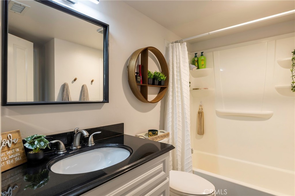 20702 El Toro Road, Unit 178 Lake Forest, CA 92630 - Photo 11 of 30 a bathroom with a granite countertop sink and a mirror