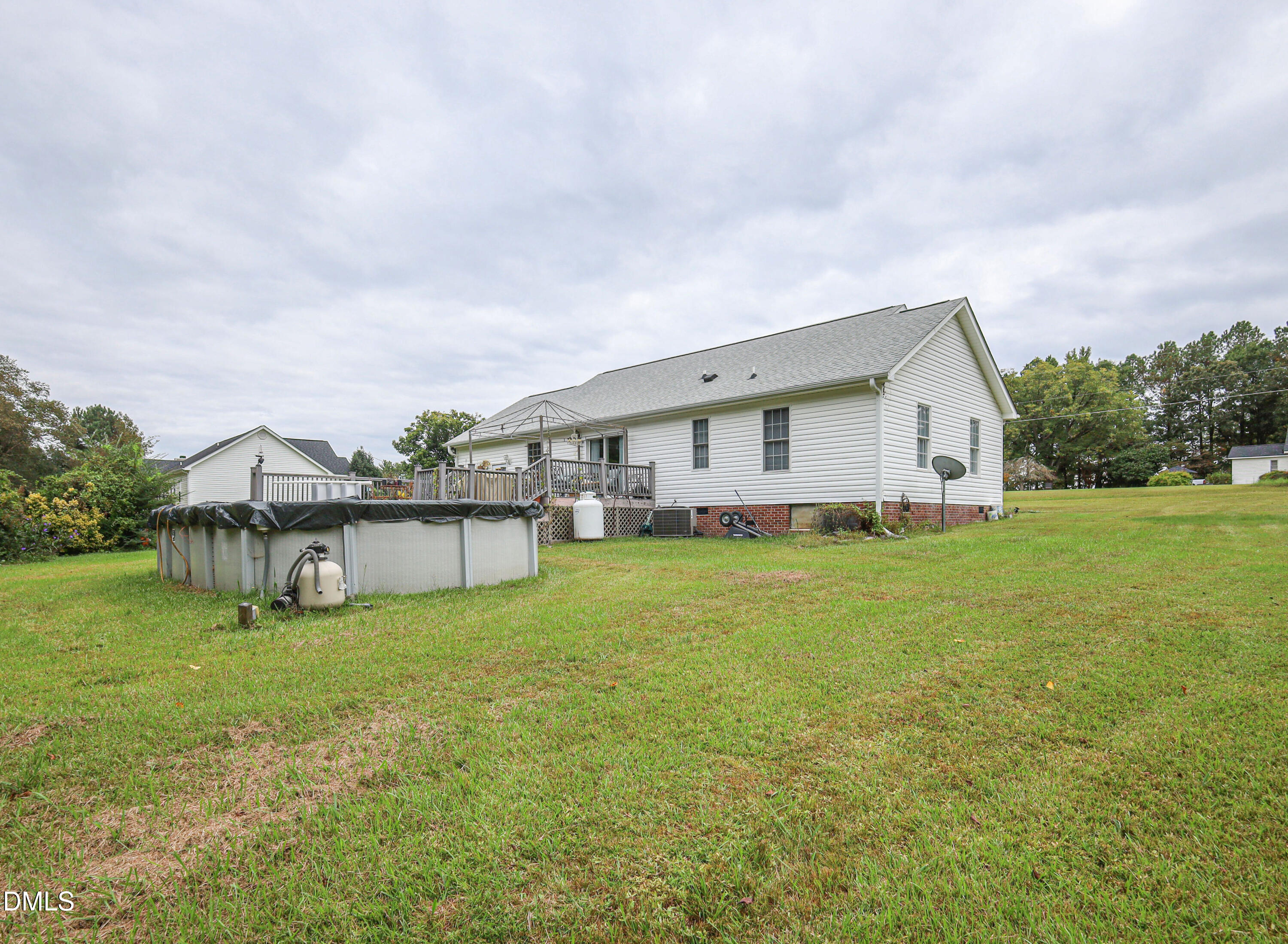 182 Scotts Lane Angier, NC 27501 - Photo 12 of 12 a view of a house with a big yard and large trees