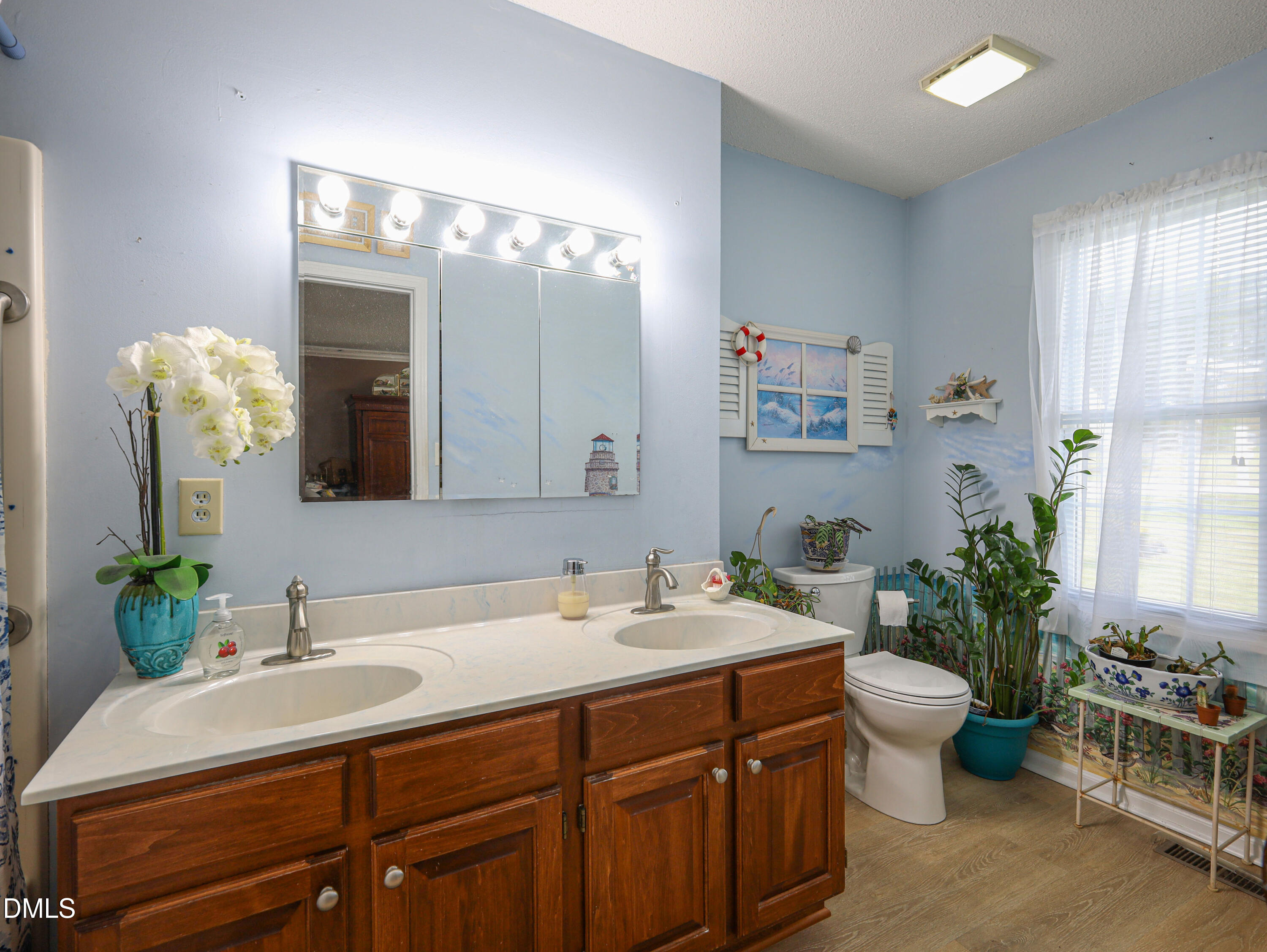 182 Scotts Lane Angier, NC 27501 - Photo 7 of 12 a bathroom with a double vanity sink and a mirror