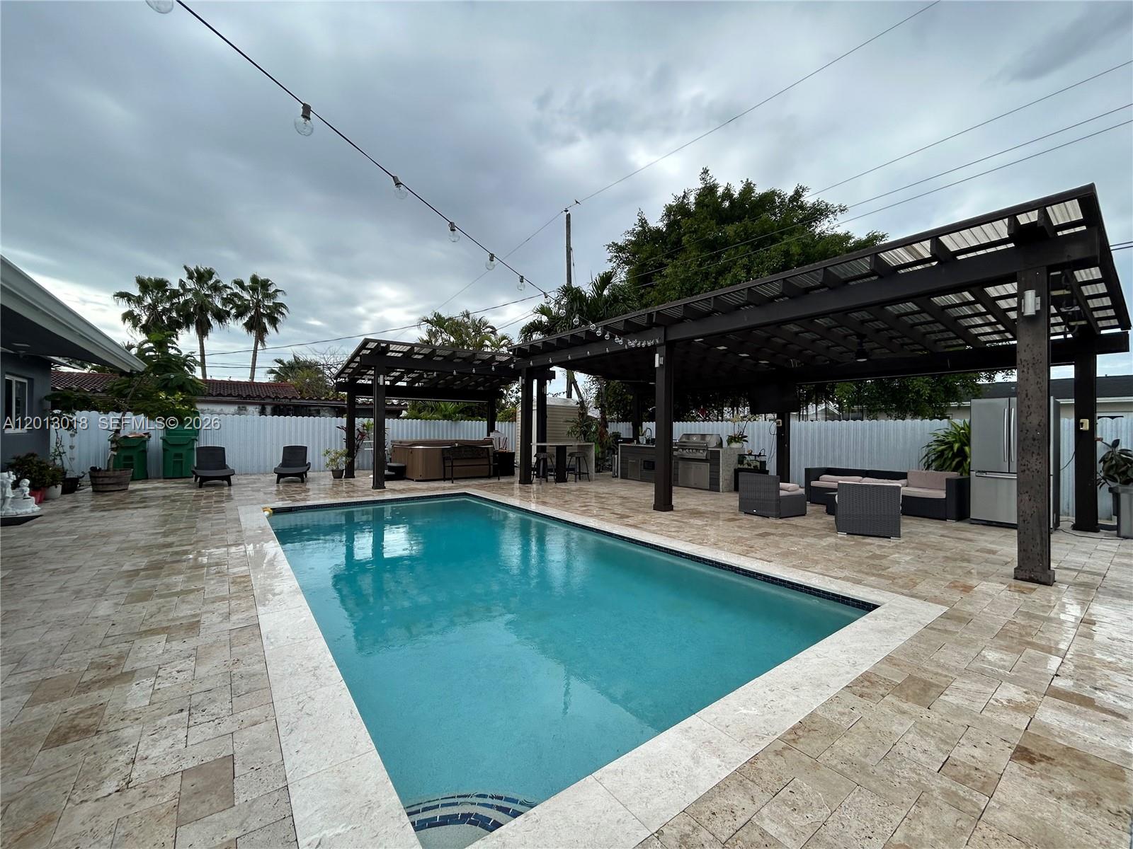 a view of a swimming pool with sitting area