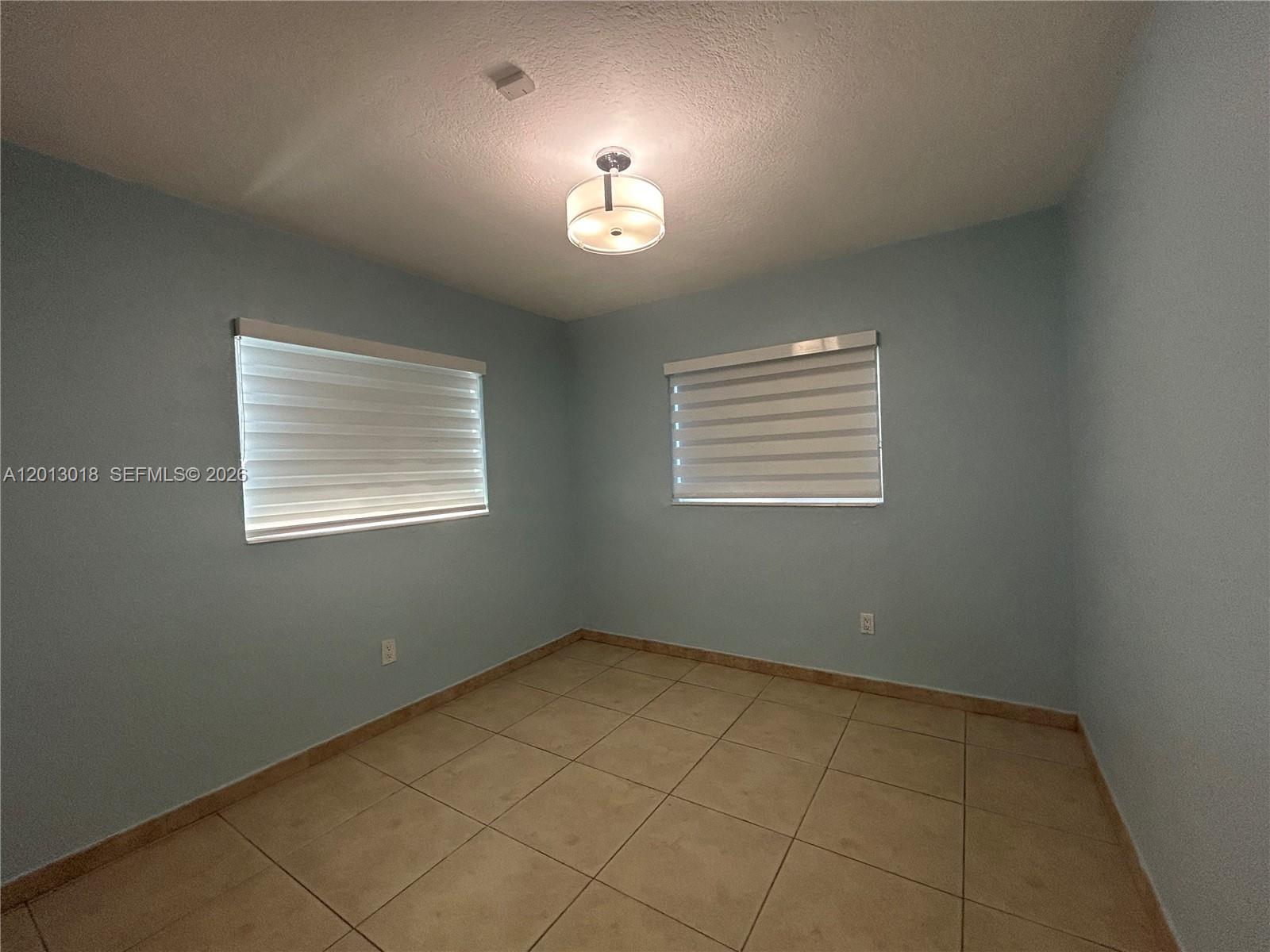 6202 Southwest 107th Avenue Miami, FL 33173 - Photo 12 of 22 a view of an empty room with a window