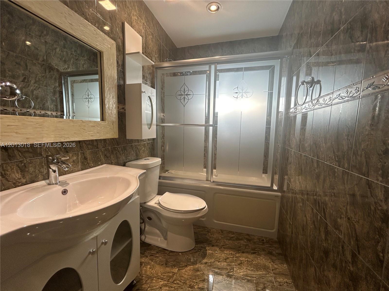 6202 Southwest 107th Avenue Miami, FL 33173 - Photo 14 of 22 a bathroom with a sink toilet and shower