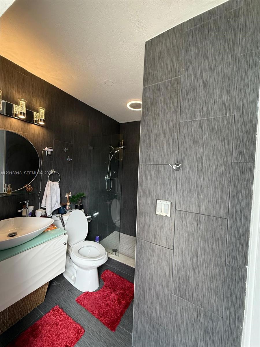6202 Southwest 107th Avenue Miami, FL 33173 - Photo 15 of 22 a bathroom with a sink a toilet and shower