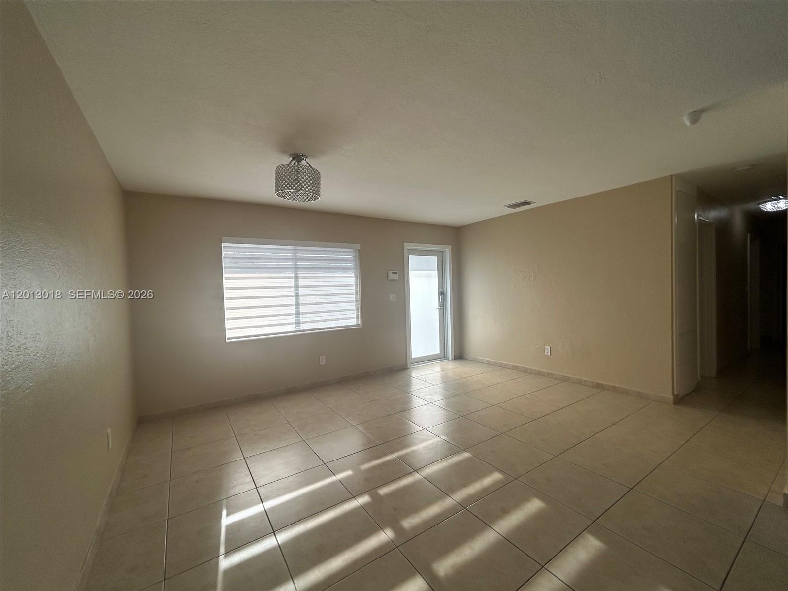 6202 Southwest 107th Avenue Miami, FL 33173 - Photo 4 of 22 a view of an empty room with a window