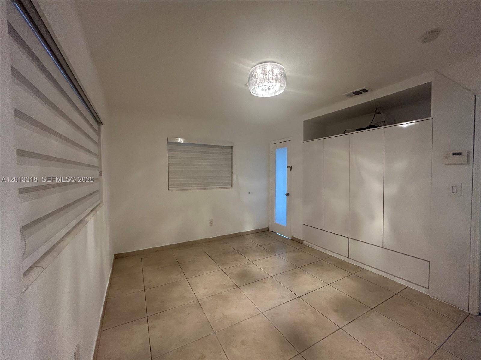 6202 Southwest 107th Avenue Miami, FL 33173 - Photo 9 of 22 a view of an empty room with a fireplace