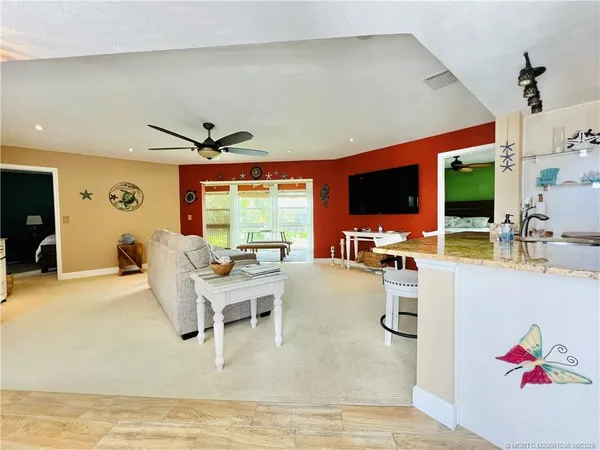 a living room with furniture and flat screen tv