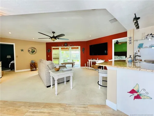a living room with furniture and flat screen tv