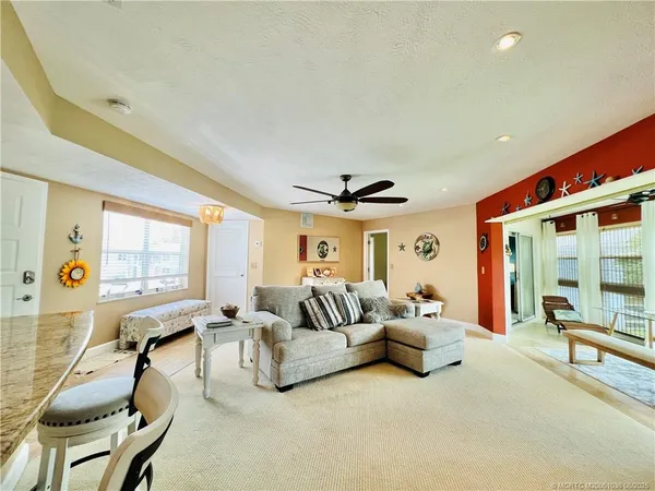 a living room with furniture gym equipment and a large window