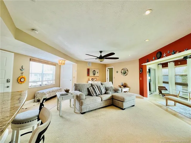 a living room with furniture gym equipment and a large window