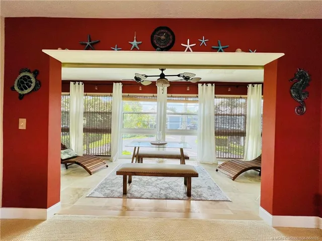 a living room with furniture and a floor to ceiling window
