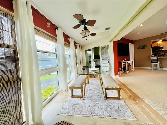 a view of a livingroom with furniture and a ceiling fan