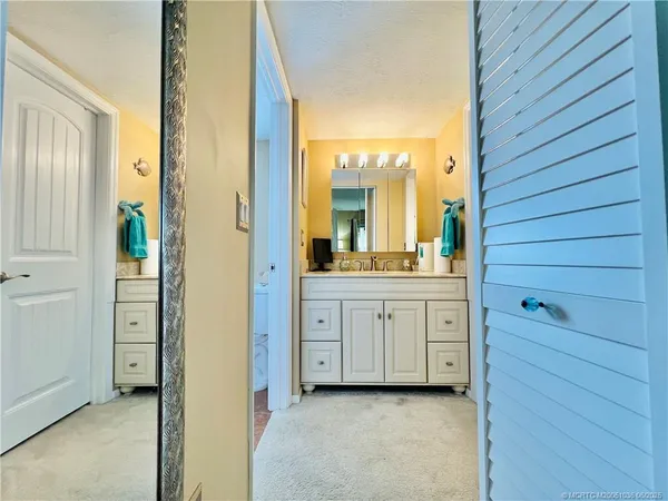 a bathroom with a double vanity sink and mirror