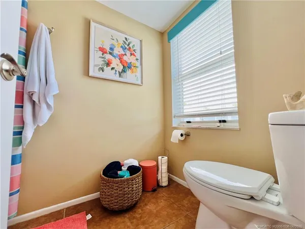 a bathroom with a toilet a sink and a window