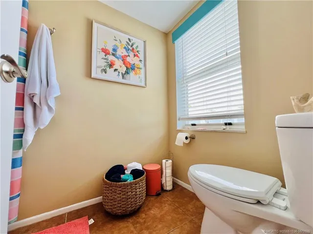 a bathroom with a toilet a sink and a window