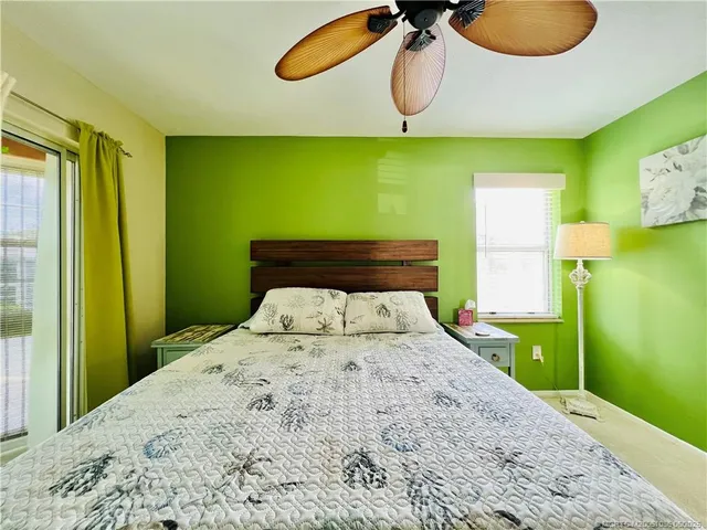 a bedroom with a bed and painting on the wall