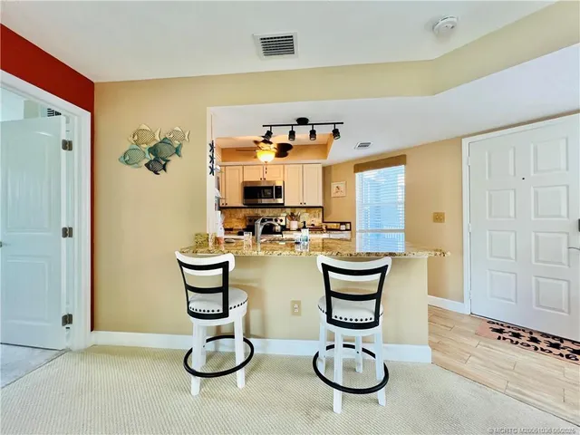 a view of a kitchen with furniture and chandelier