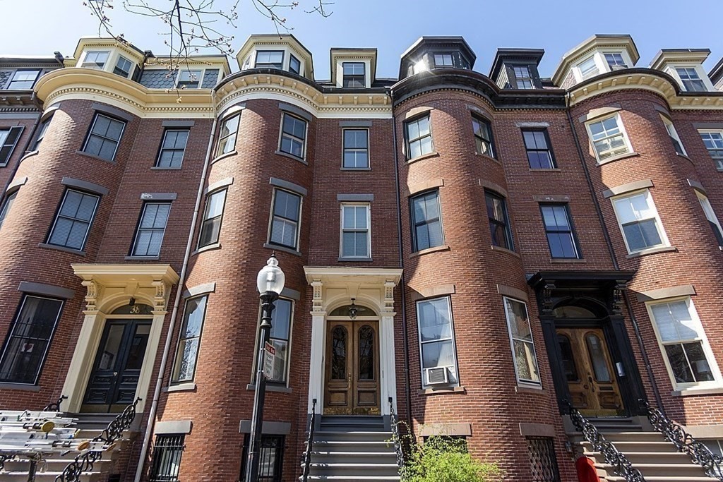 40 Rutland Square, Unit 5 Boston, MA 02118 - Photo 17 of 19 a view of a brick building with large windows