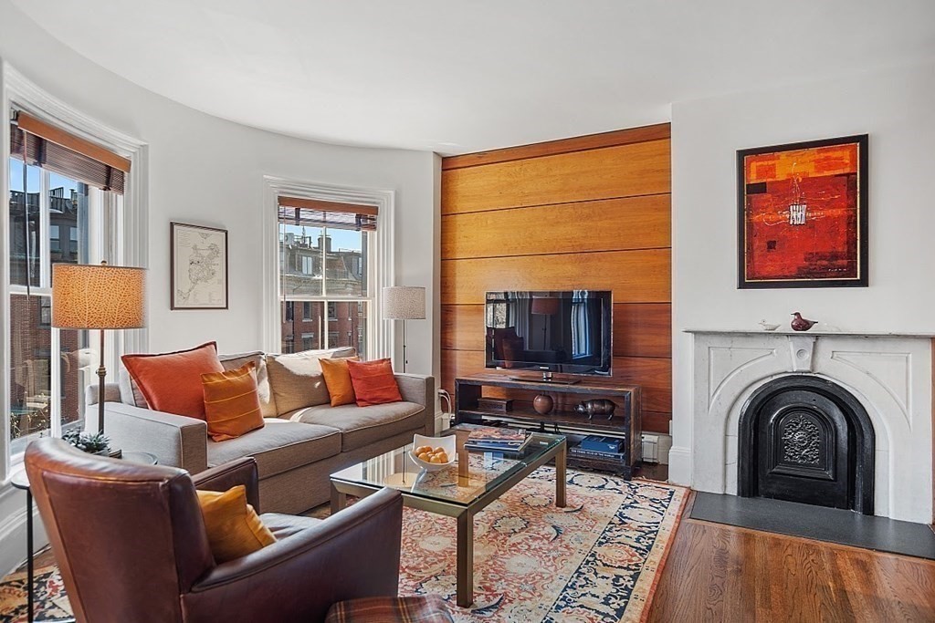 40 Rutland Square, Unit 5 Boston, MA 02118 - Photo 4 of 19 a living room with furniture a fireplace and a flat screen tv