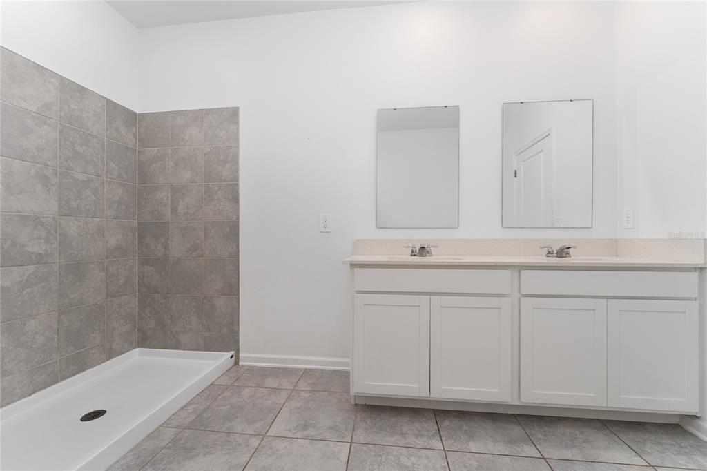 566 Hatteras Road Davenport, FL 33837 - Photo 13 of 28 a bathroom with a sink and a bathtub