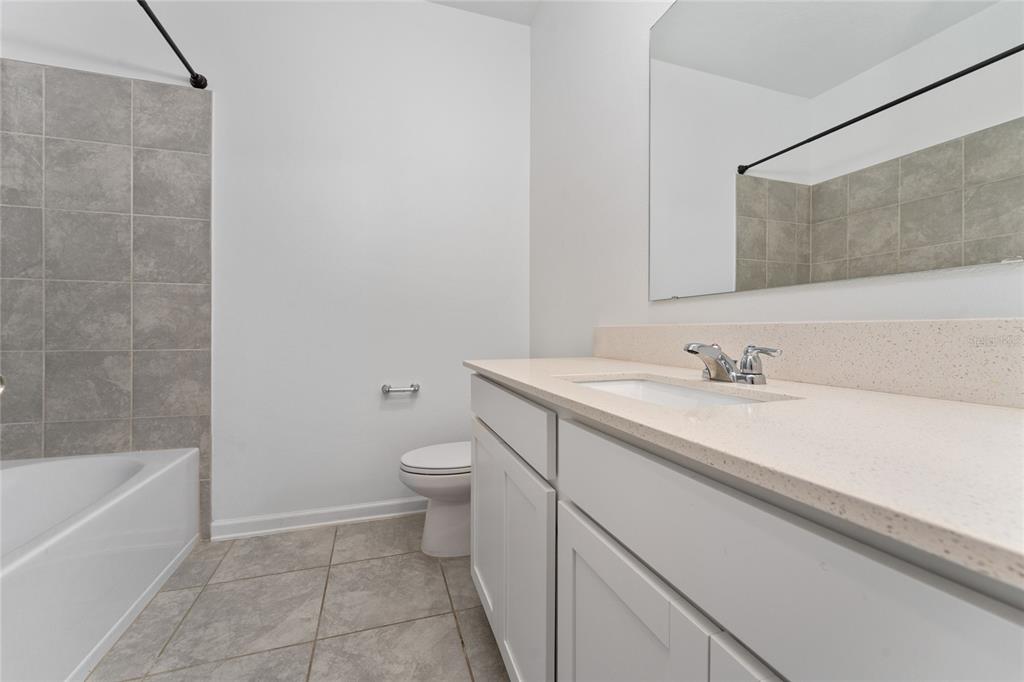 566 Hatteras Road Davenport, FL 33837 - Photo 20 of 28 a bathroom with a sink a toilet and bathtub