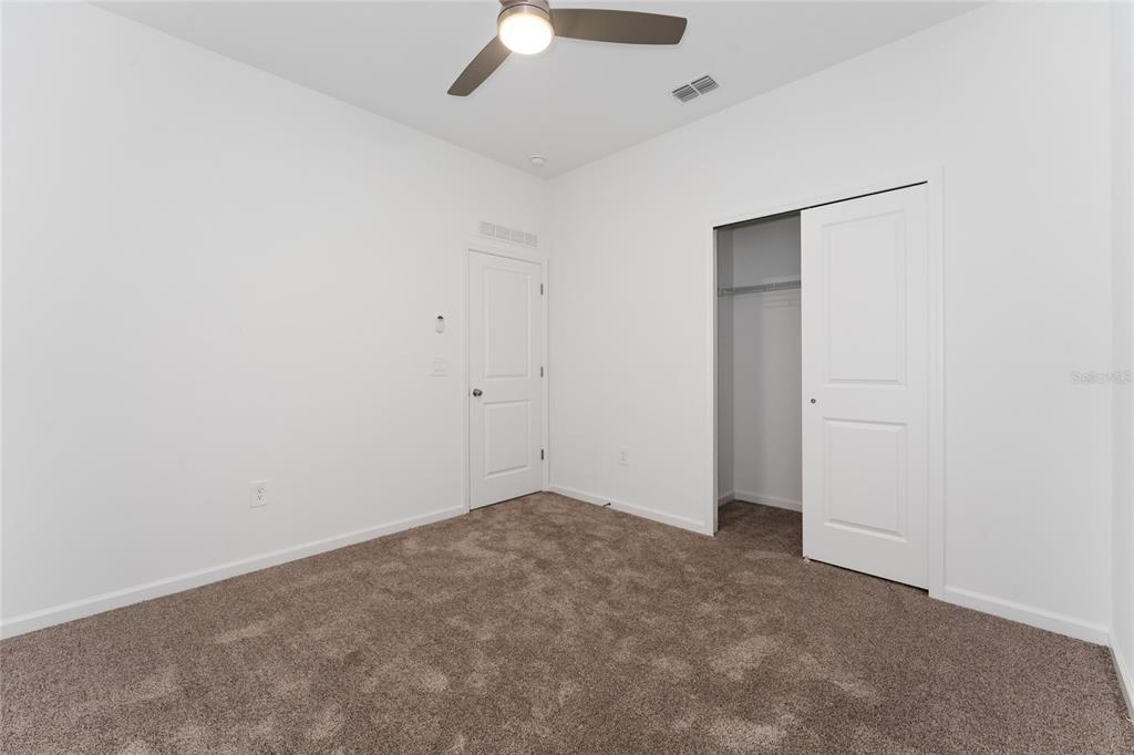 566 Hatteras Road Davenport, FL 33837 - Photo 22 of 28 an empty room with a ceiling fan and a window
