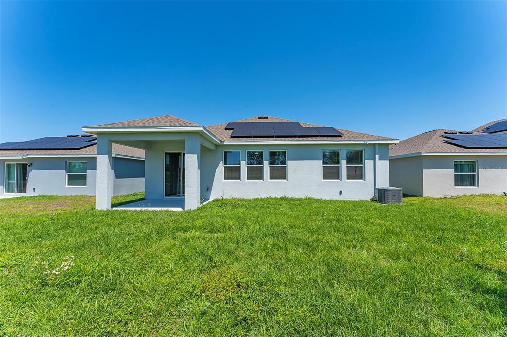 566 Hatteras Road Davenport, FL 33837 - Photo 25 of 28 a front view of a house with a garden