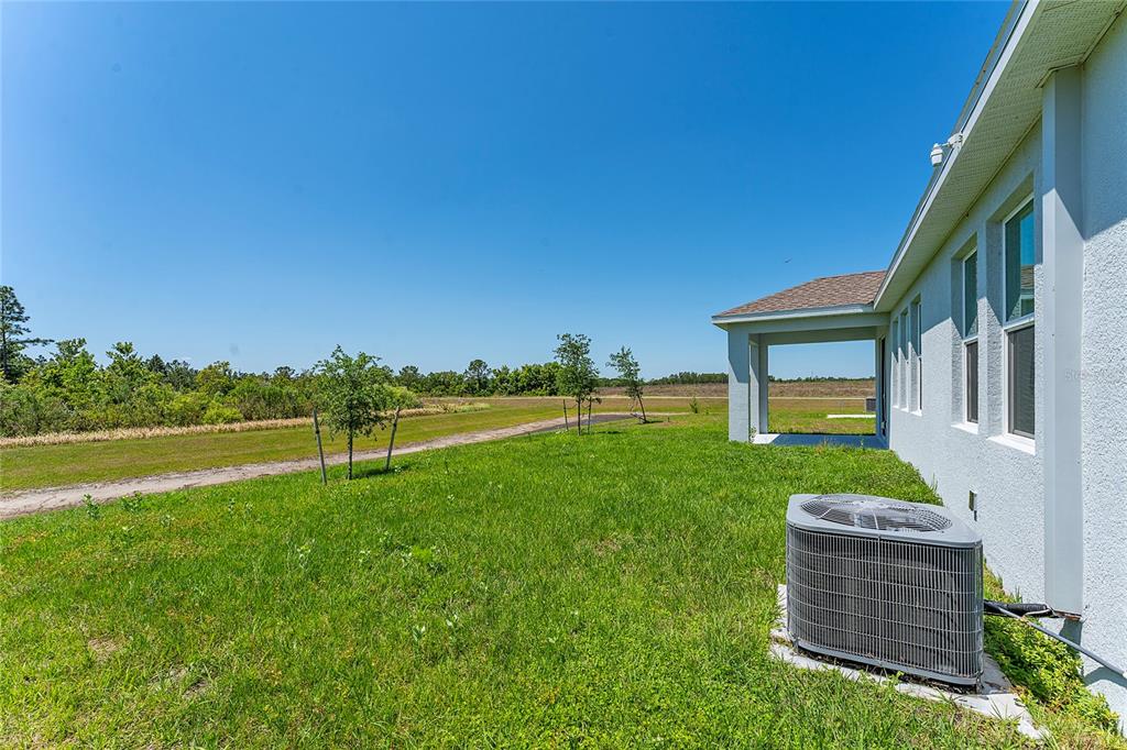 566 Hatteras Road Davenport, FL 33837 - Photo 27 of 28 a view of a house with a backyard