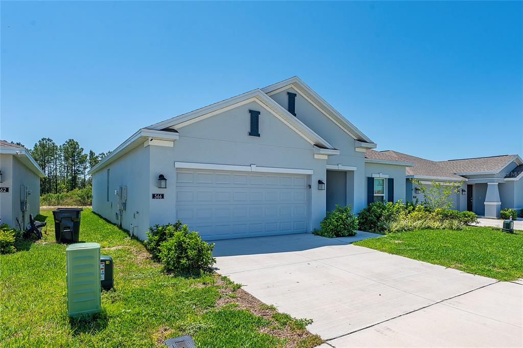 566 Hatteras Road Davenport, FL 33837 - Photo 3 of 28 a front view of a house with a yard