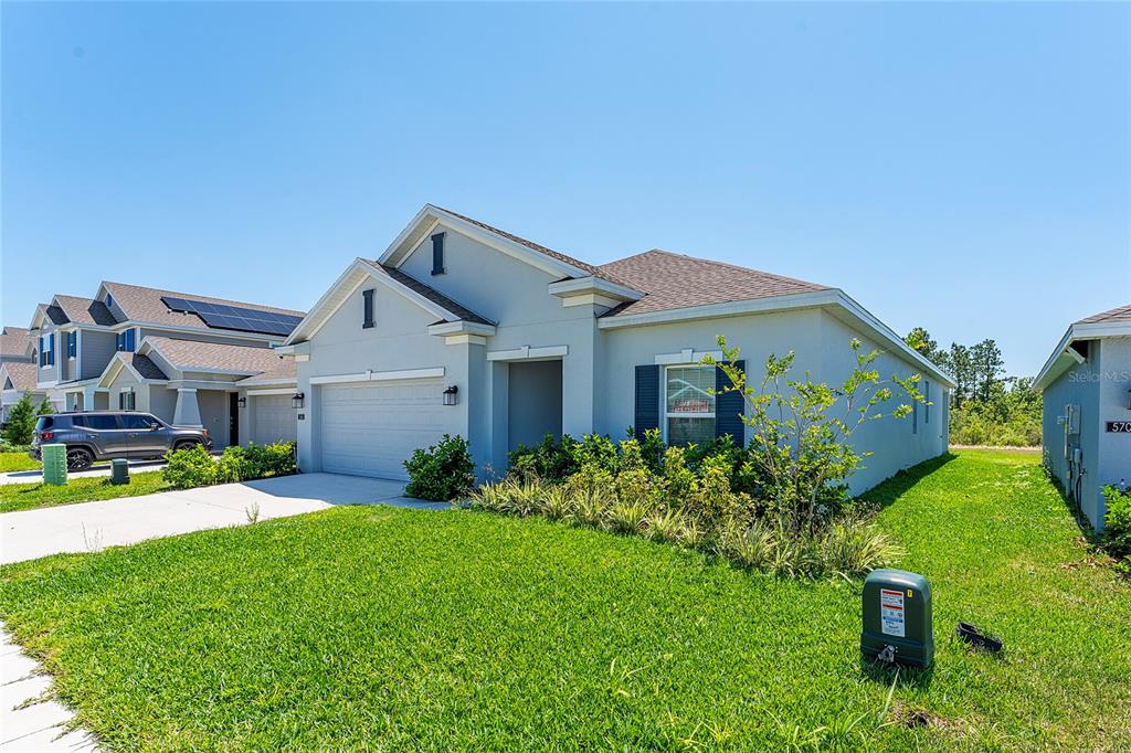 566 Hatteras Road Davenport, FL 33837 - Photo 4 of 28 a front view of house with a garden